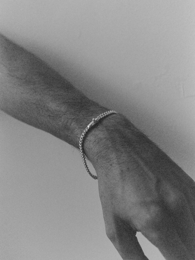 Black and white arm wearing J. Hannah Identity Bracelet II
