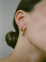 Model wearing J. Hannah Diamond Charm Hoop in 14k Gold huggie