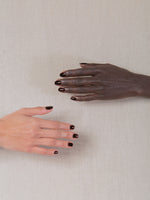 Two hands wearing J. Hannah nail polish in Carob.