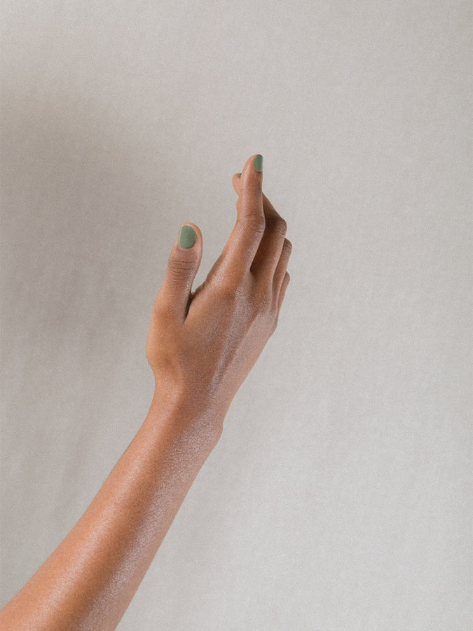 Right hand wearing J. Hannah nail polish in Artichoke.