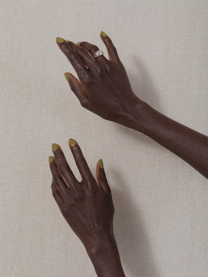 Hands wearing J. Hannah nail polish in Eames and Form II Ring silver